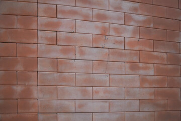 Angled perspective of a classic red brick wall showing texture and pattern.