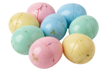 Pile of dirty old vintage pastel colored plastic toy capsules isolated on a transparent background
