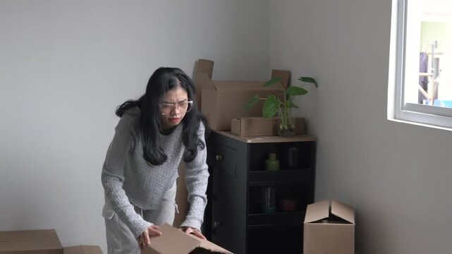 Young woman confusedly looking for lost items when moving to new house