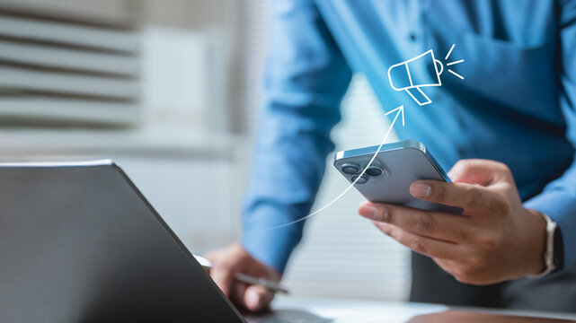 campaign, roas, ads, spend, return, A businessman using smartphone and laptop with digital marketing campaign icon, representing advertising performance, ROI, ROAS, and online marketing analytics.