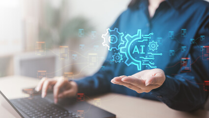 A person using a laptop with AI technology graphics symbolizes automation, artificial intelligence, and data-driven innovation for smarter workflow and productivity.