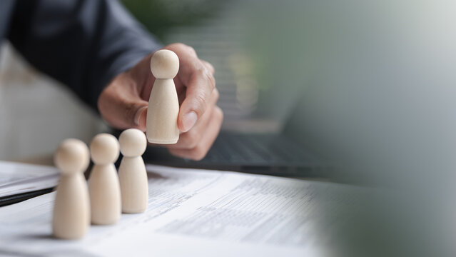 hiring, recruitment, hr, employee, selection, Business person selecting wooden human figures, representing hiring process, employee recruitment, and talent management in human resource development.