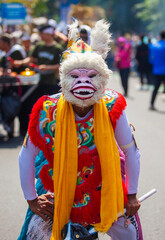 A performer dressed as Hanuman, the white monkey god from the Ramayana epic, participates in the Asia Africa Festival cultural parade in Bandung, showcasing Indonesian wayang heritage