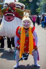 A performer dressed as Hanuman, the white monkey god from the Ramayana epic, participates in the Asia Africa Festival cultural parade in Bandung, showcasing Indonesian wayang heritage