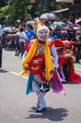 A performer dressed as Hanuman, the white monkey god from the Ramayana epic, participates in the Asia Africa Festival cultural parade in Bandung, showcasing Indonesian wayang heritage