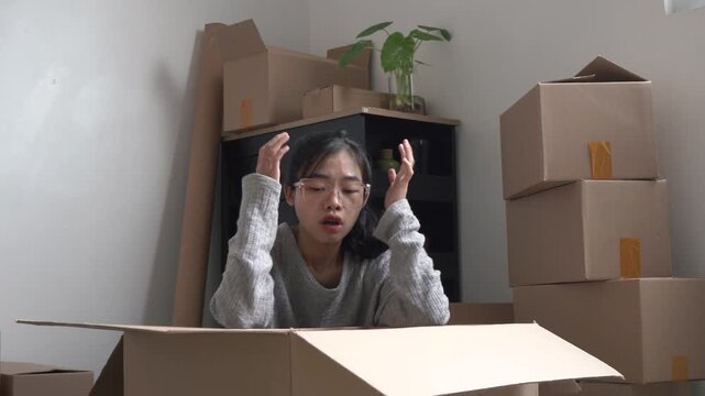 Young woman confusedly looking for lost items when moving to new house