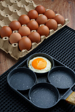 Fried Egg and Brown Eggs on Wooden Table