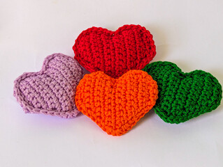 A delightful collection of vibrantly colored, hand-knitted heart-shaped decorations, perfect for expressing love and affection