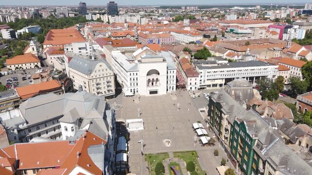 Scenic drone view over Timisoara&rsquo;s Victory Square, showcasing the iconic National Opera House with the urban square and nearby buildings.