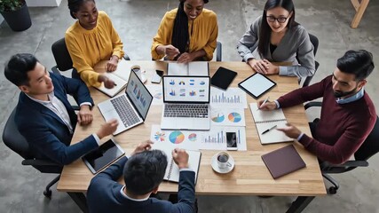 Diverse professionals collaborating on business strategy financial analysis and data driven insights during a modern office meeting - Powered by Adobe