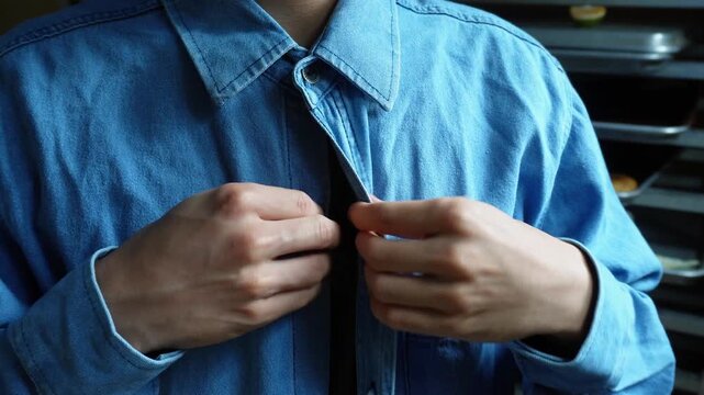 man buttoning his denim cloth