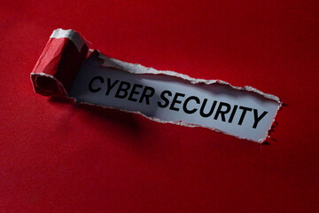 Torn paper revealing CYBER SECURITY message on red background.