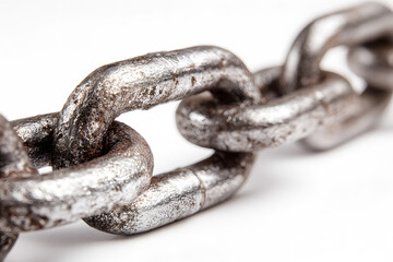 Large old rusty chain is ring of interconnected links long on white background. Made by forming loop of metal such as iron or stainless steel and stringing loops together.