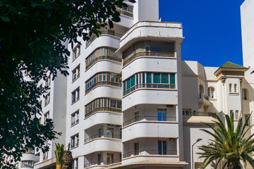 Modern high-rise buildings and office towers in the city center of Morocco against a clear blue sky.