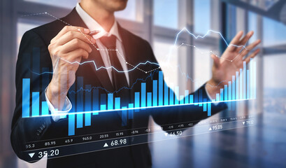 A businessman engages with digital charts and graphs to analyze financial data in a contemporary...
