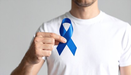 Man displaying a blue awareness ribbon as a symbol of support for health causes, disease prevention, and solidarity. A powerful image for public awareness campaigns