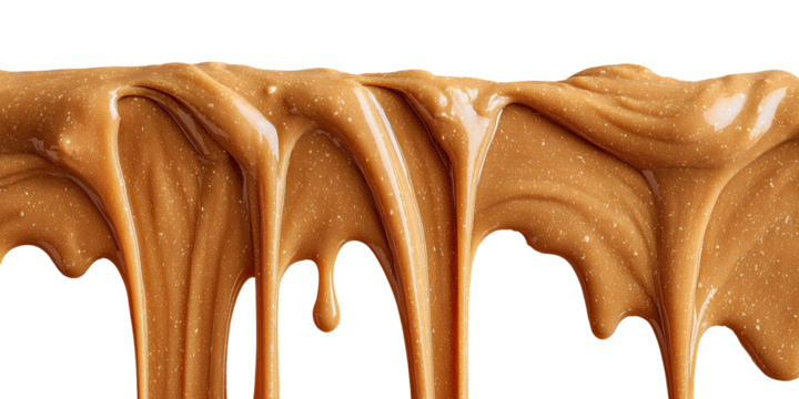 Drips of smooth, golden-brown creamy caramel or fudge against black