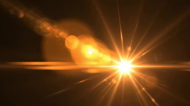 A beautiful cinematic golden orange anamorphic lens flare with warm bokeh light effects on a black background