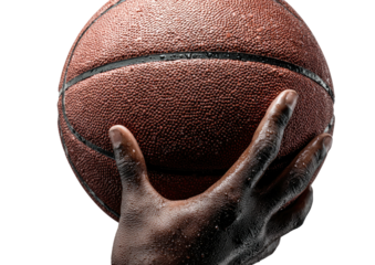 Wet basketball held in hand against black background