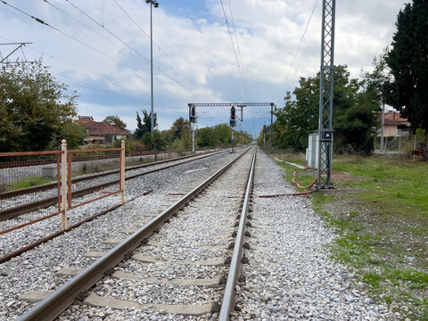 Scenic railroad tracks extending into the horizon under cloudy skies