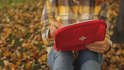 First aid kit. Autumn Park. Female teacher. High-quality photo.