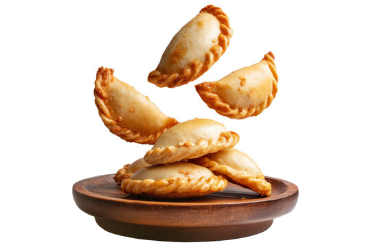 Argentina and Uruguay empanadas stacked in a pyramid, golden baked crust, meat and potato filling on wooden plate, isolated on white transparent background, concept of traditional South American Cuisi