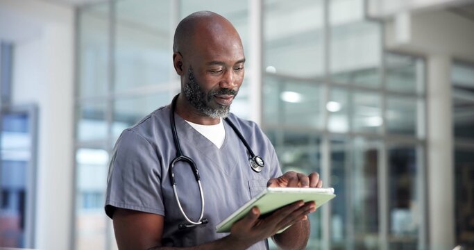 Tablet, surgeon and black man in clinic for medical history, review report or research. Healthcare professional, tech and mature nurse reading email for wellness, hospital schedule or telehealth - Powered by Adobe