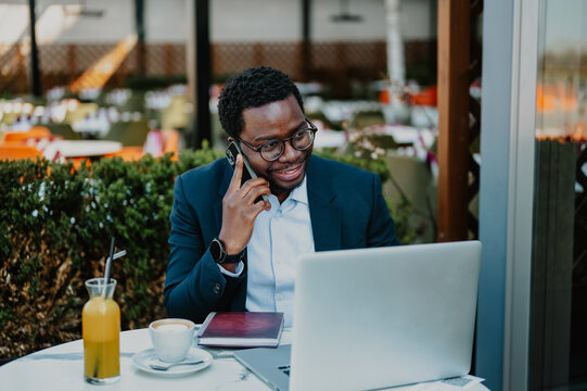 African american man making phone call working outdoors - Powered by Adobe