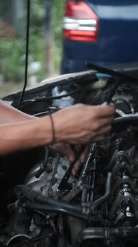 car mechanic changing car engine