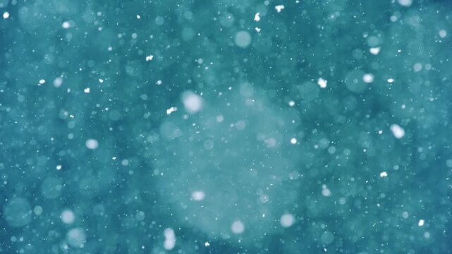 Peaceful winter scene with snowflakes falling slowly on blue blurred background