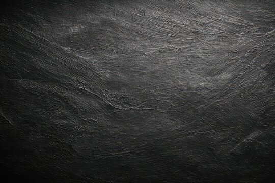 Dark textured chalkboard and grunge blackboard surface ideal for creative writing, drawing, and artistic displays in various settings such as classrooms and cafes