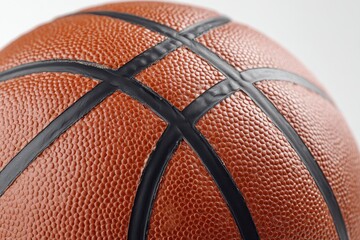 Fototapeta premium Realistic basketball ball resting over a clean white background showcasing detailed texture and design elements for sports enthusiasts and design inspiration