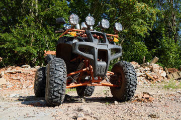 Off-road vehicle parked in a forested area during daylight