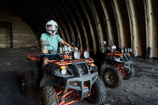 Riding ATVs in an abandoned building during daylight hours