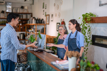 Mother, son and daughter are working at their DIY store.