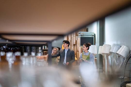 Mother, son and daughter are working at their DIY store. - Powered by Adobe