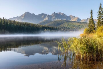 Fototapeta premium Majestic mountain lake with serene misty reflections