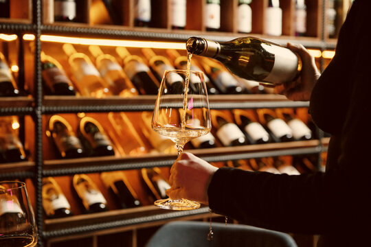 Sommelier Pouring White Wine into Glass