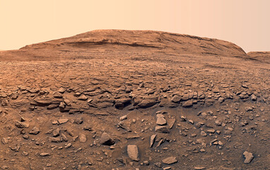 A desolate martian landscape with rocky terrain and dusty hills.