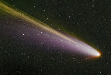 A luminous comet with a long tail in outer space.