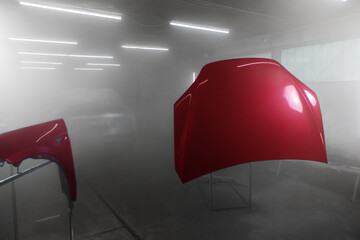 Painted parts of automobile body in auto service. Restoration painting of car in the paint chamber service.