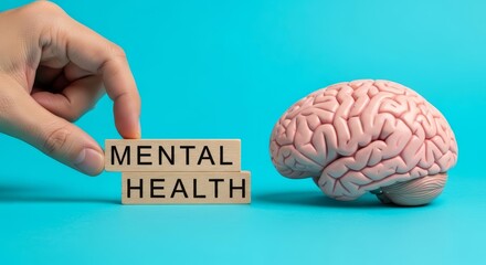 Hand Placing Wooden Blocks for Mental Health with Brain Model on Blue