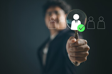 Businessman selecting candidate with magnifying glass, symbolizing recruitment, job search, human resources, hiring process, talent acquisition employee selection in modern workforce.