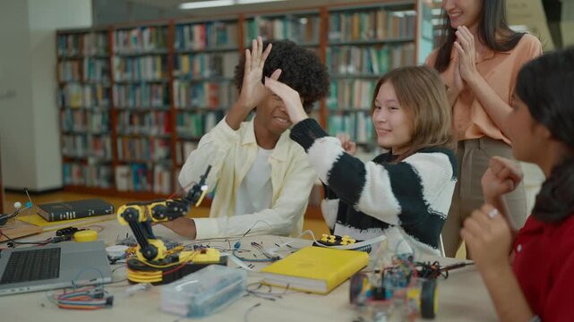 Group of students learning together to build electronic car model construction project. Innovative technology development