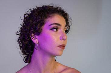 Studio photograph of a woman with curly hair