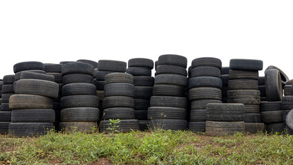 Low angle view of isolated piles of car tires left on the ground ready to be reused at a car repair shop, a common sight in rural Thailand.
