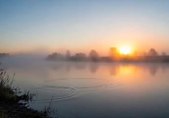 Naklejka premium Tranquil river landscape illuminated by the warmth of the sunrise