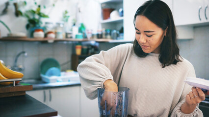 Asian woman, blender and smoothie for health in kitchen, detox diet or wellness. Fruit mixer, home...