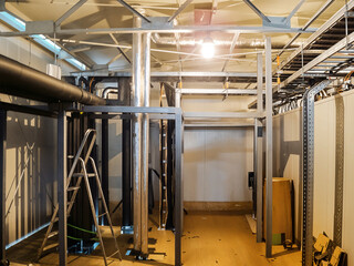 Industrial interior with pipes, metal structures, and a ladder