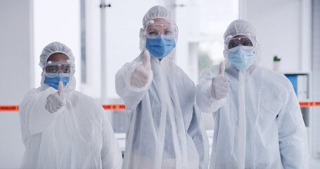 Portrait, people and scientist thumbs up with protective suit for agreement, disinfection and team...